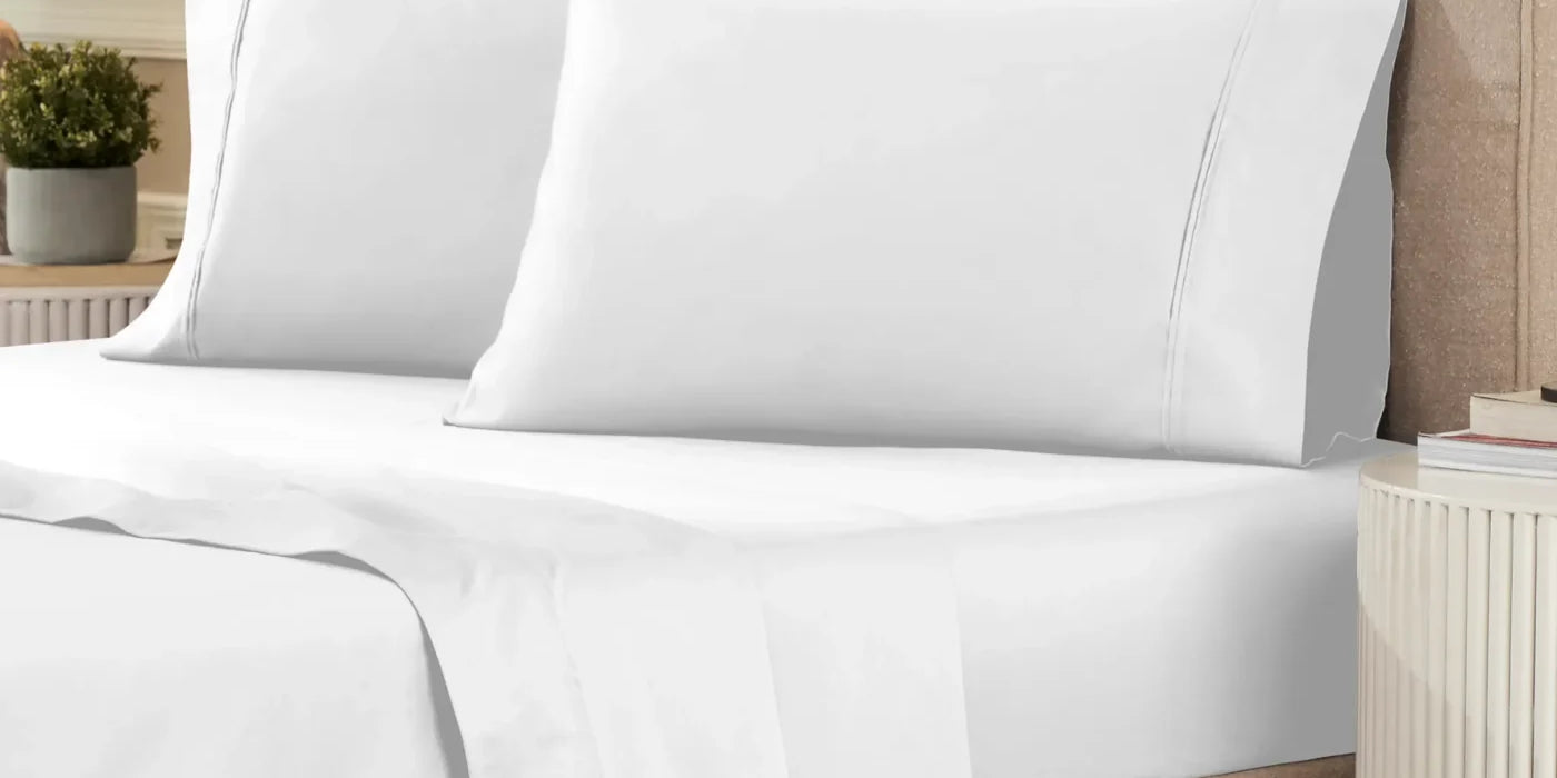 Superior 1200 thread count Egyptian cotton sheet set in white on a made bed