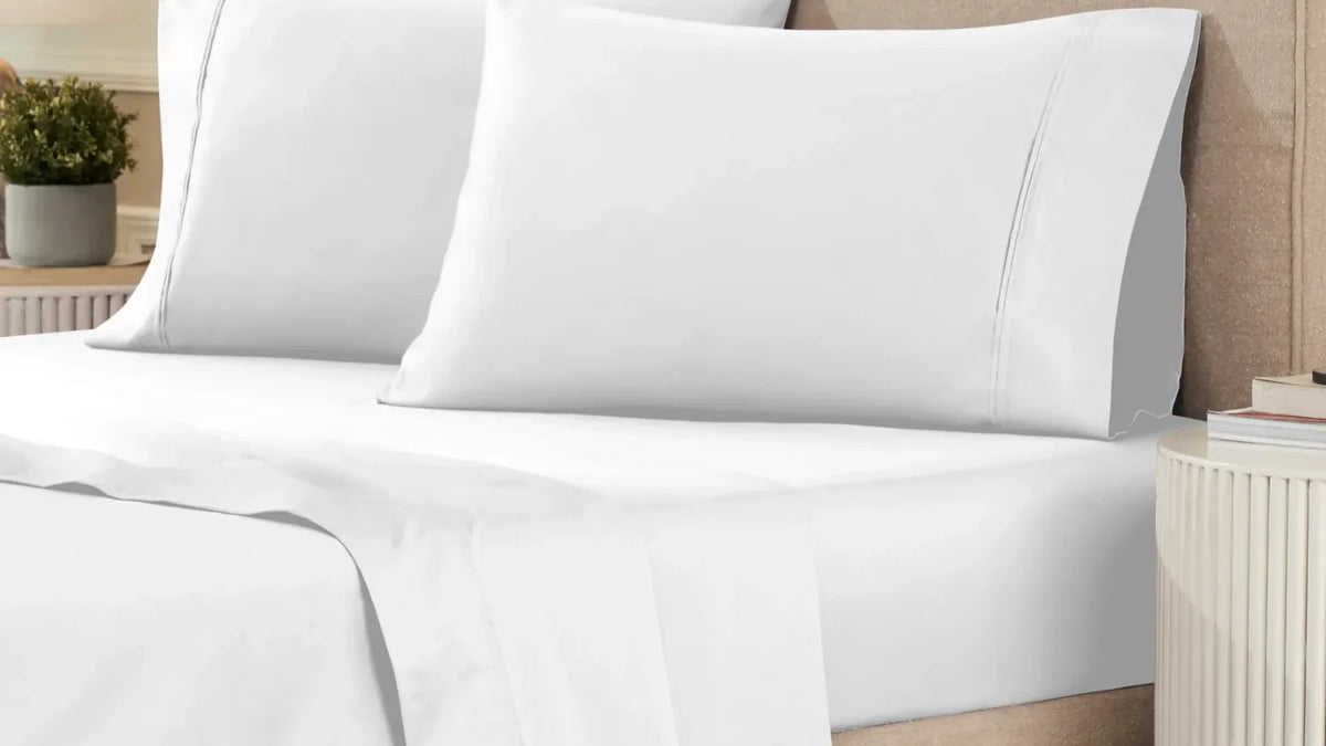 Superior 1200 thread count Egyptian cotton sheet set in white on a made bed