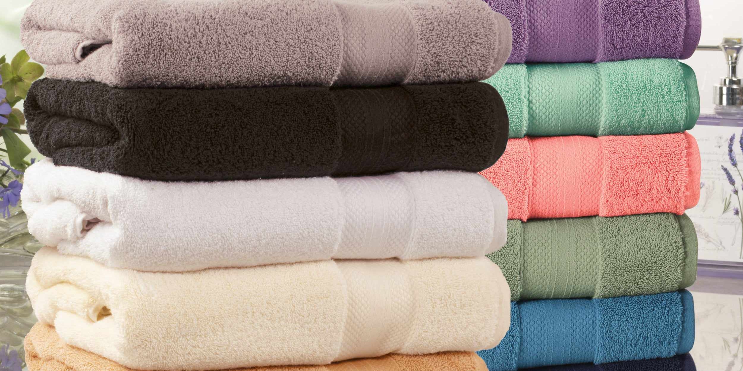 Stacks of Superior cotton bath towels in a range of colours by a bright window