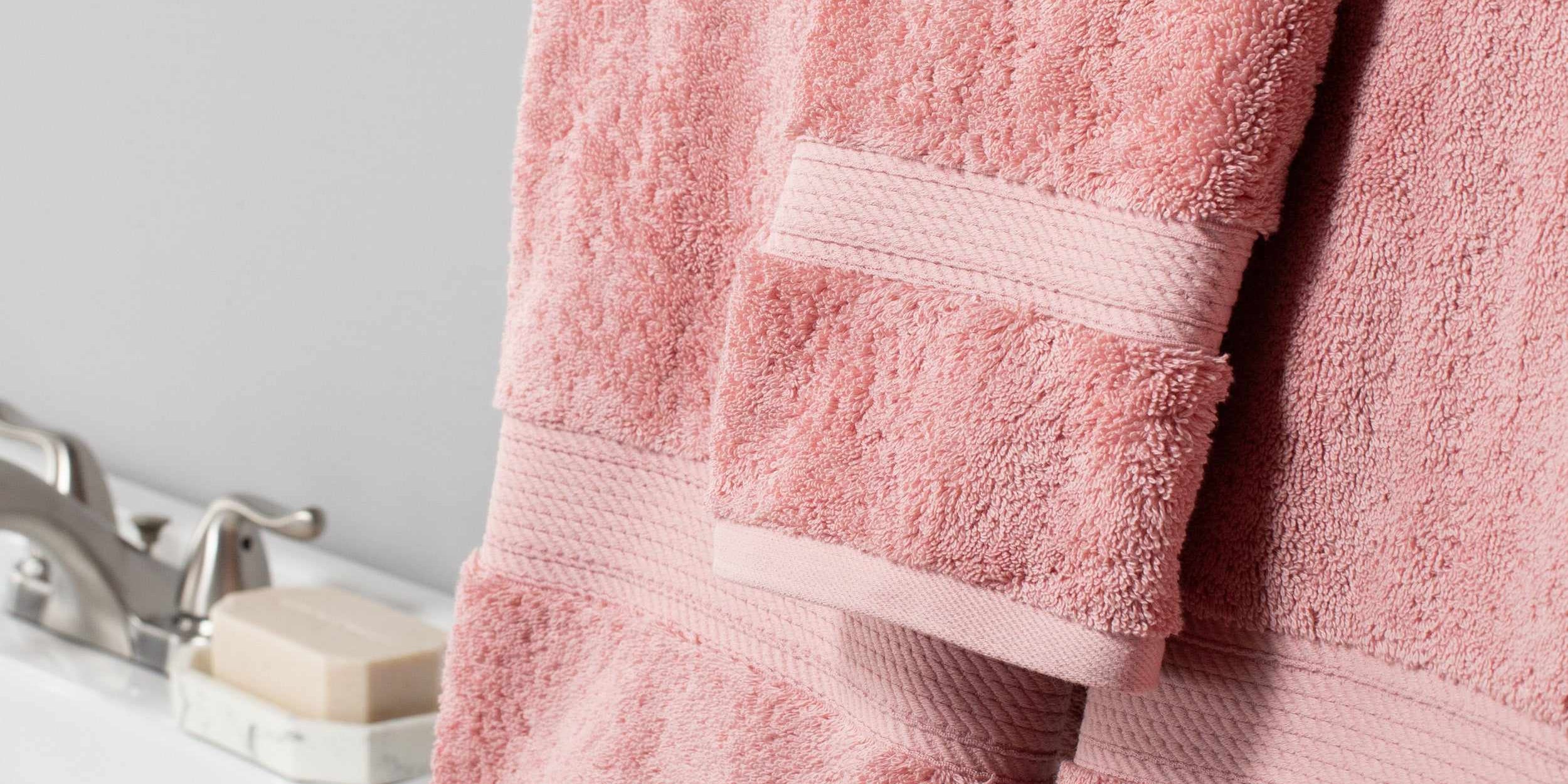 Superior soft cotton towels in tea rose hanging in a bathroom