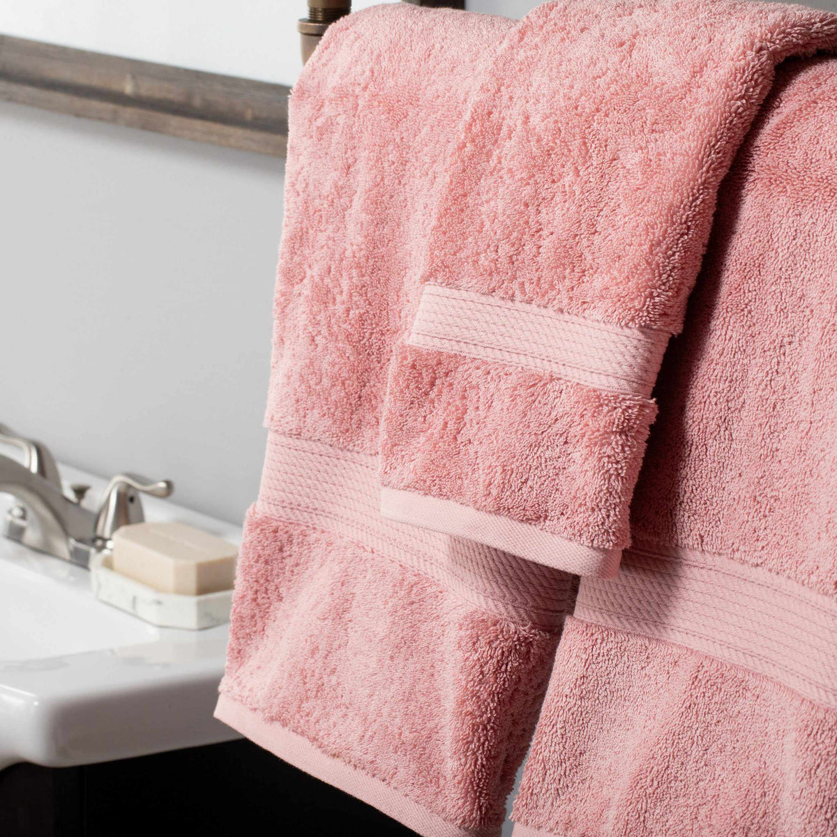 Superior soft cotton towels in tea rose hanging in a bathroom